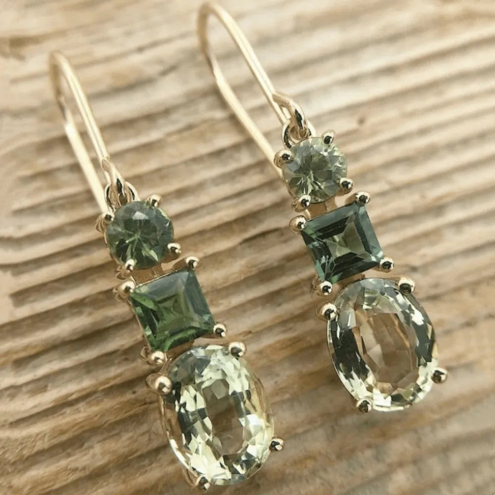 A pair of green geometric quadrilateral copper earrings in a bohemian style for unisex wear.