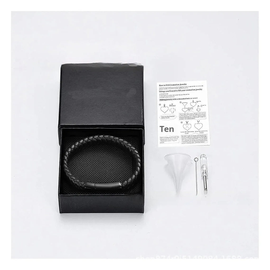 Black stainless steel bracelet with leather cinerary charm and engraved text, presented in a gift box.