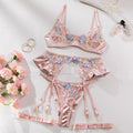 Light purple satin lingerie four-piece set with embroidery detailing on a hanger.