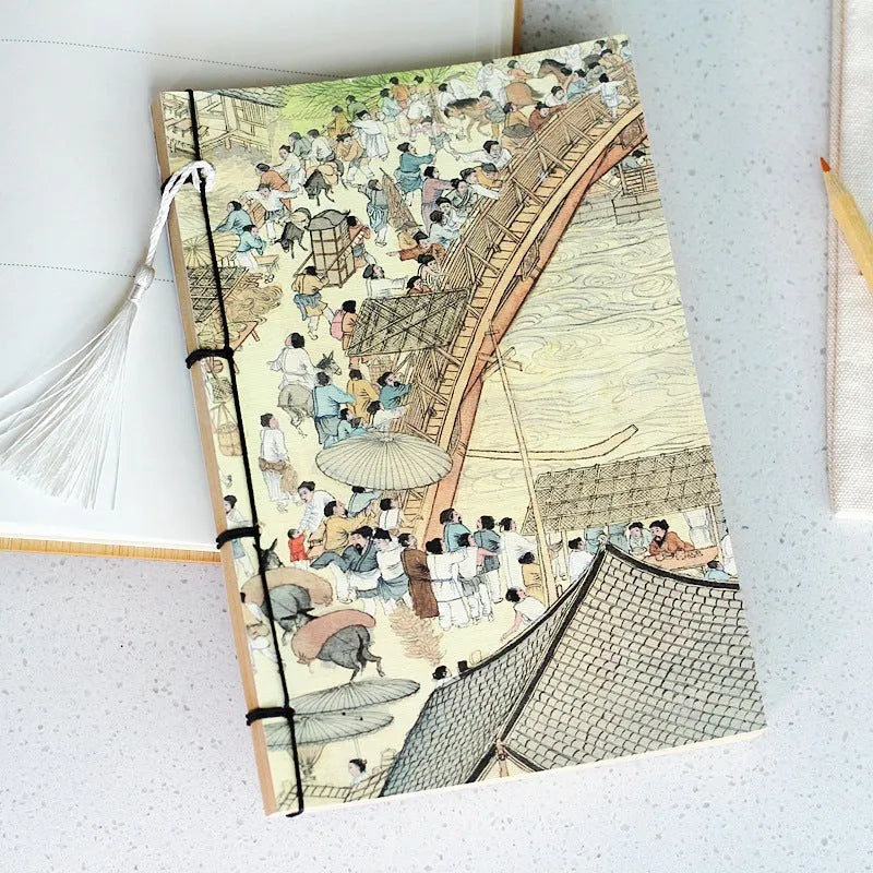 A5 antique wire-bound notebook with glossy embossed cover featuring a retro painting design, shown open.