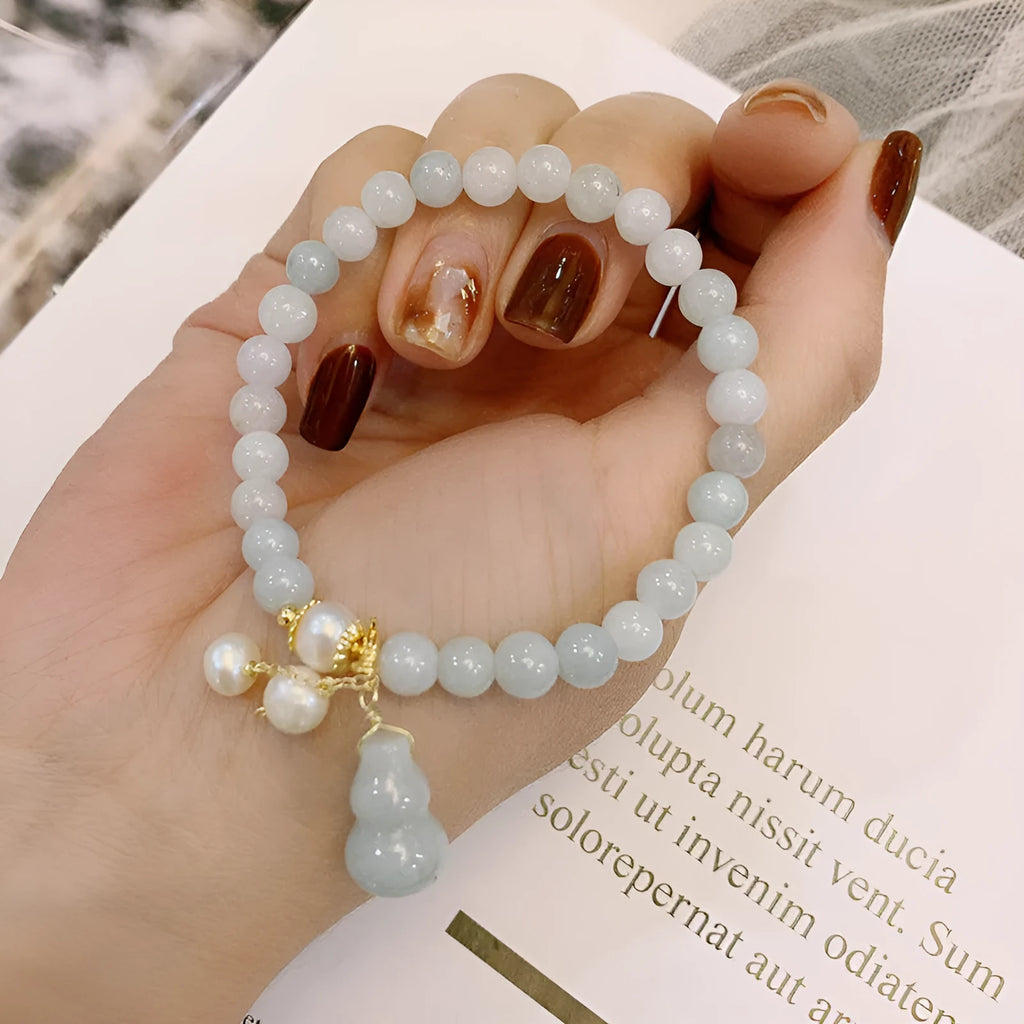 Natural jade bracelet with hand-carved gourd design in Chinese women's style.