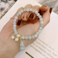 Natural jade bracelet with hand-carved gourd design in Chinese women's style.