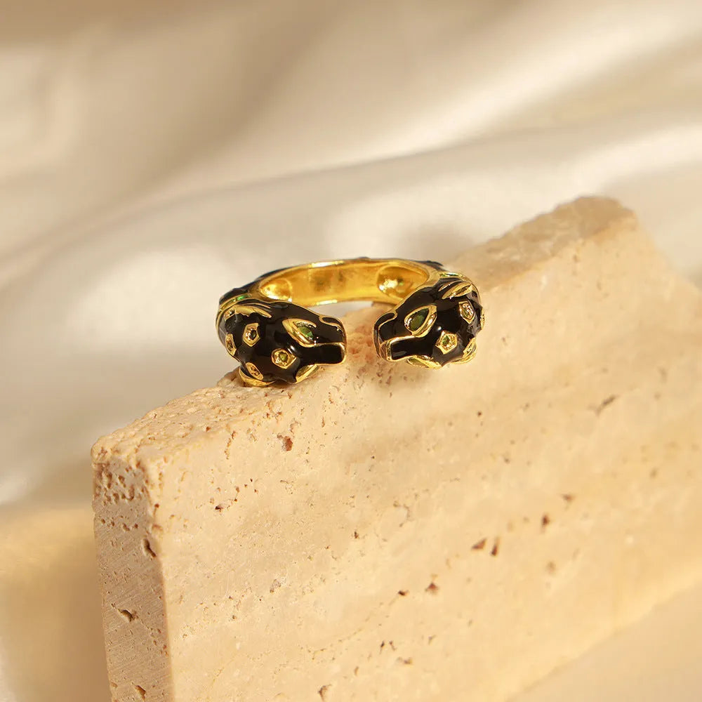 Black cheetah print geometric open ring on finger showing electroplated copper construction