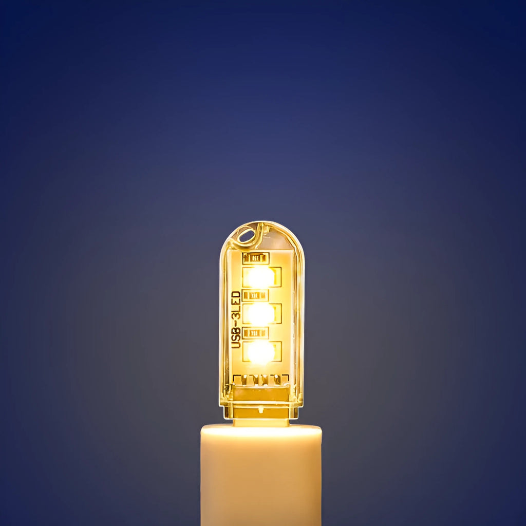 Small white LED night light showing warm and cool light options with USB charging port
