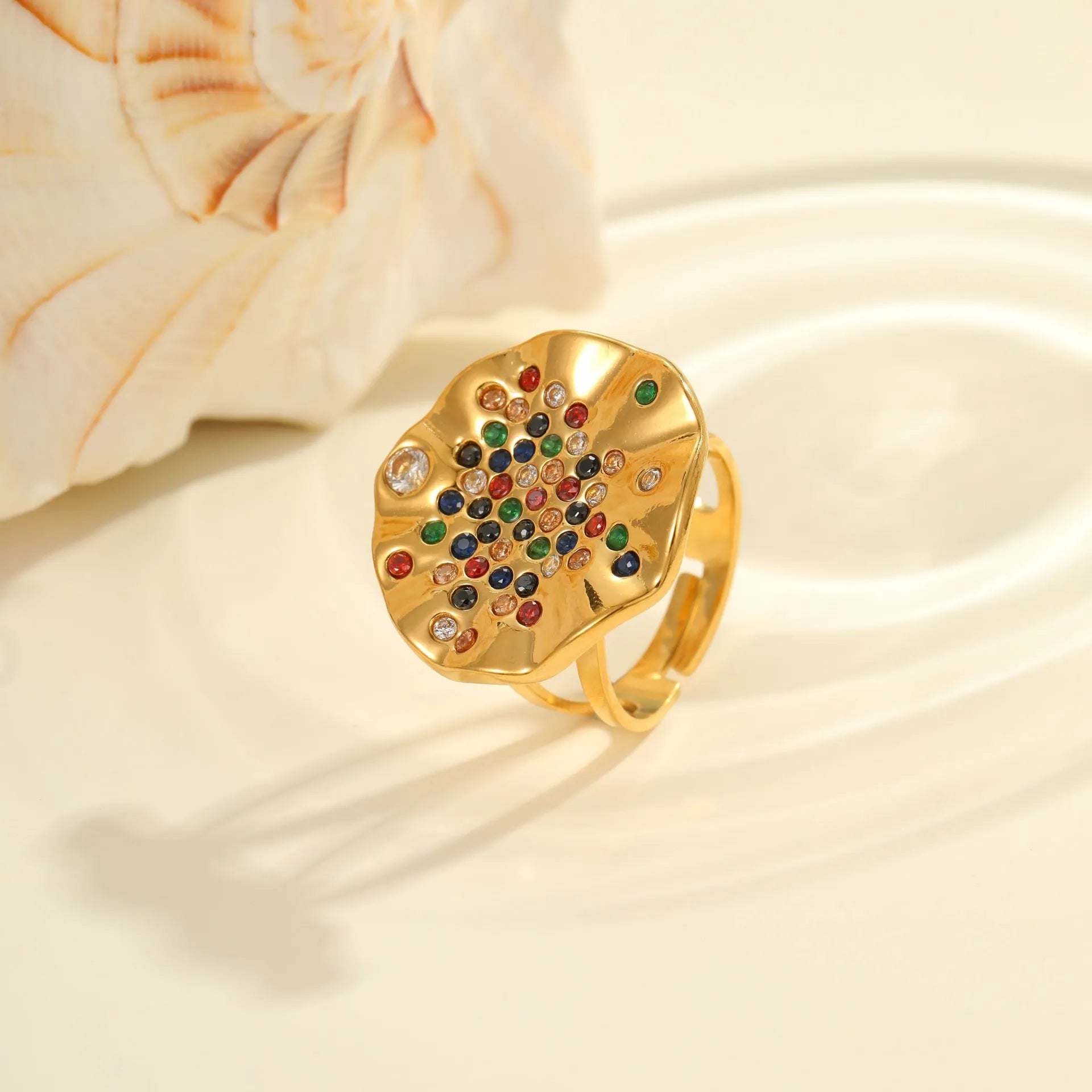 Pleated geometry open mouth ring with inlaid colourful crystals on electroplated stainless steel band.
