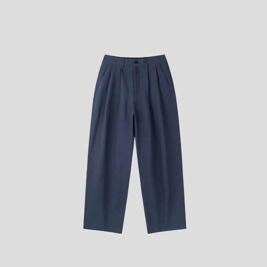 Men's apricot-coloured wide-leg cotton linen trousers with an elastic waistband on a hanger.