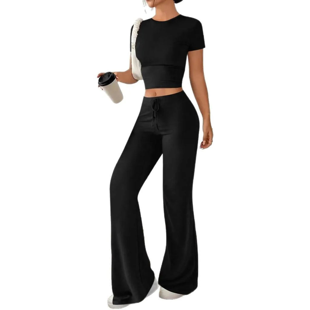 Women's black high waist trousers and regular sleeve t-shirt two-piece set laid flat.