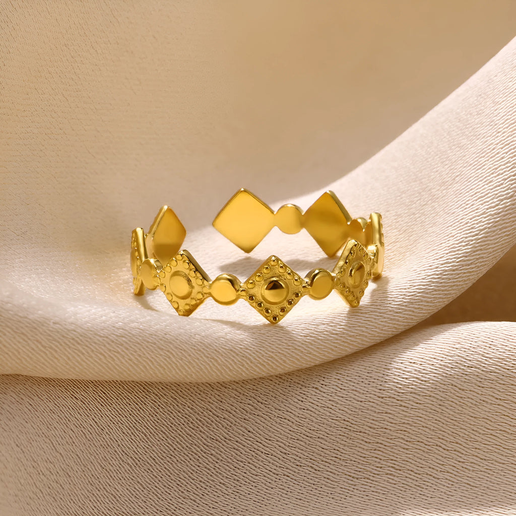 Gold diamond coloured titanium steel geometric women's ring on a free size band.