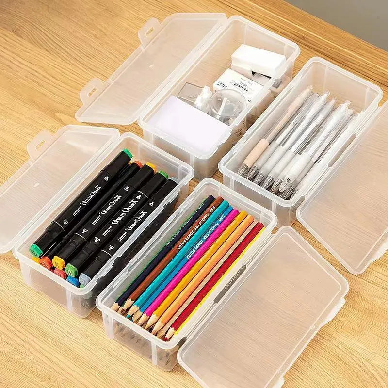 Transparent plastic stationery storage box containing pencils, colour leads, and art supplies