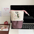 Korean style cartoon collapsible pencil case made from Oxford fabric in brown colour, shown with pens inside.