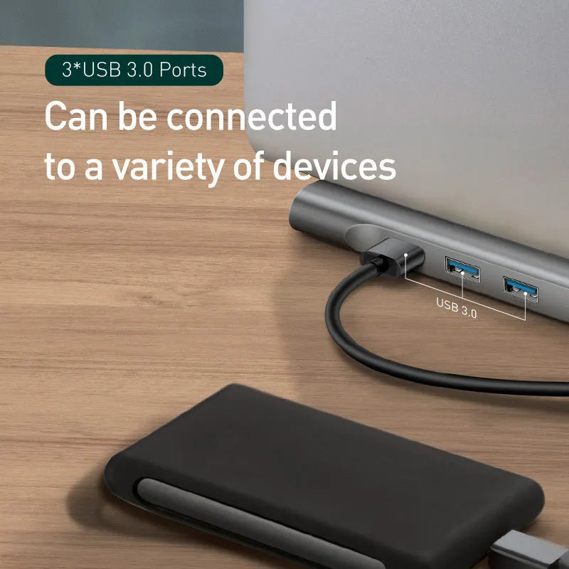 Grey aluminium ten-port USB hub docking station with cooling bracket on a desk.