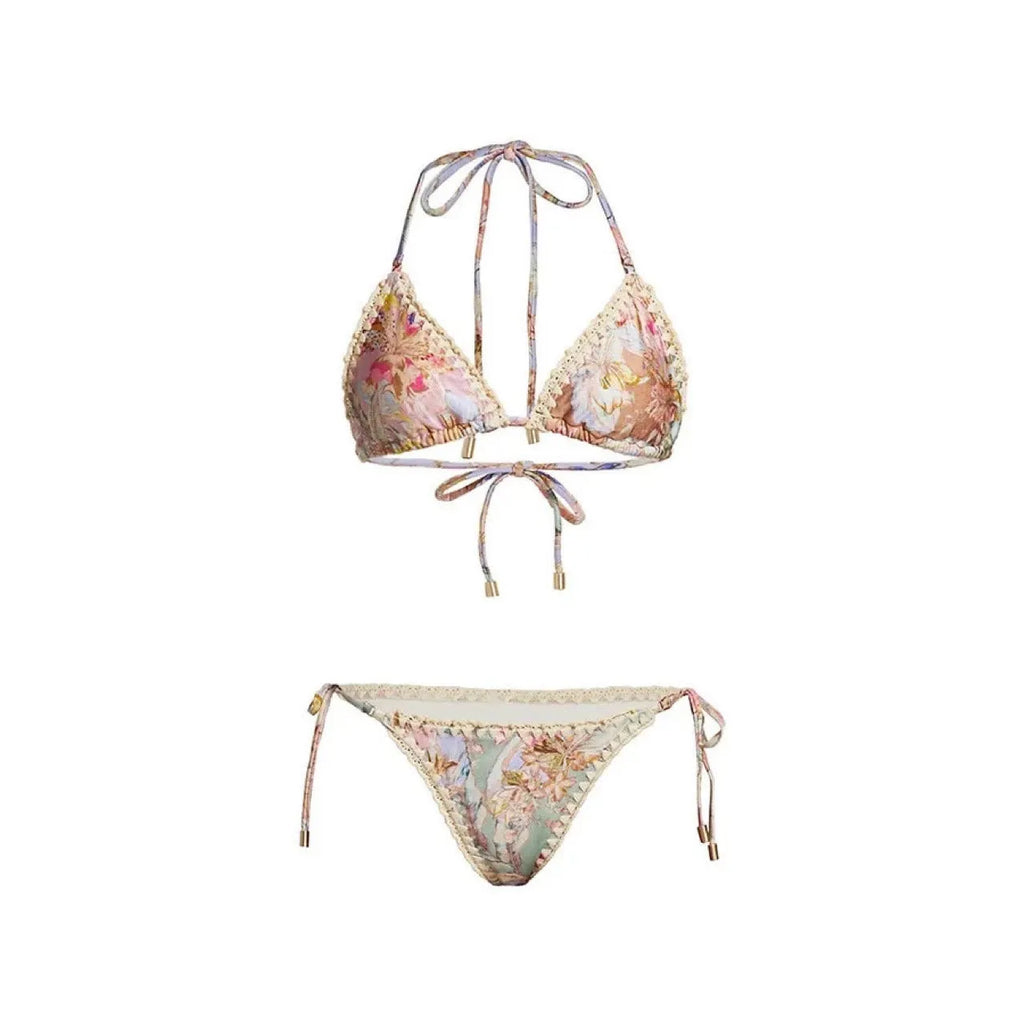 Creamy white women's floral bikini set with top, briefs, and matching skirt on a mannequin.