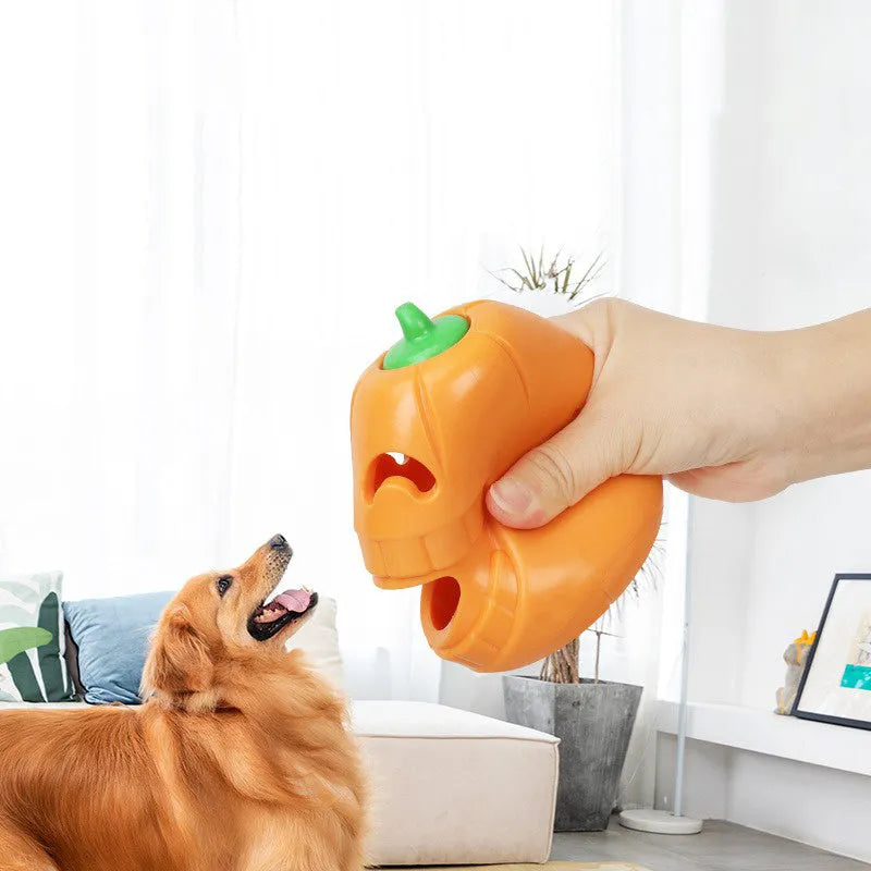 Orange Halloween pumpkin shaped interactive dog chew toy made of thermoplastic rubber with treat dispensing funnel design for all breed sizes