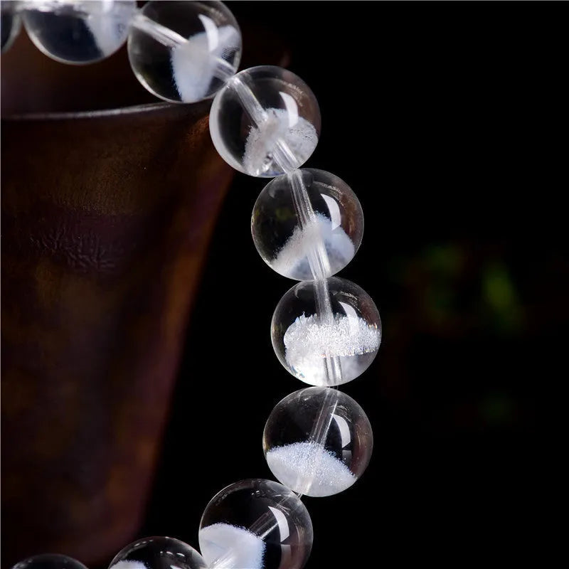 Women's white crystal ghost pyramid bead bracelet with Ruyi symbol design.