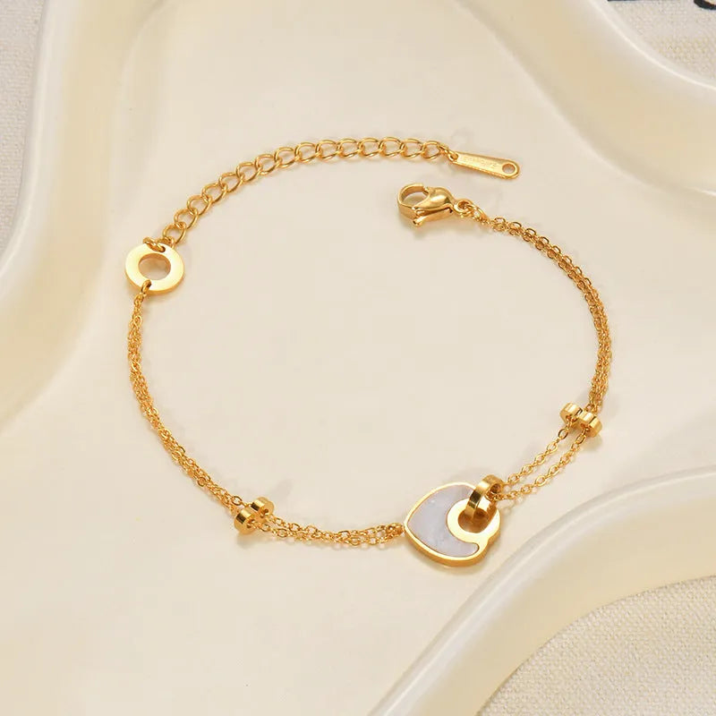Women's stainless steel bracelet with a double-layer resin heart pendant.