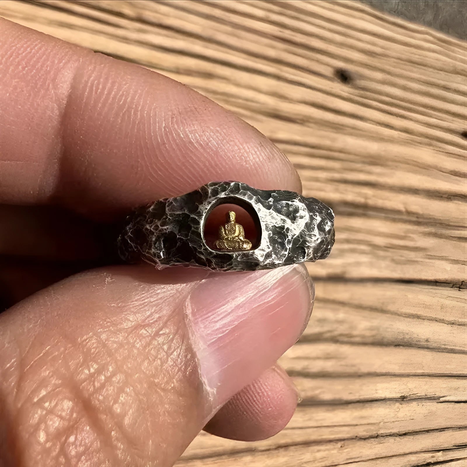 Hand-forged copper ring with rock texture featuring grotto Buddha design, shown in UK size 8