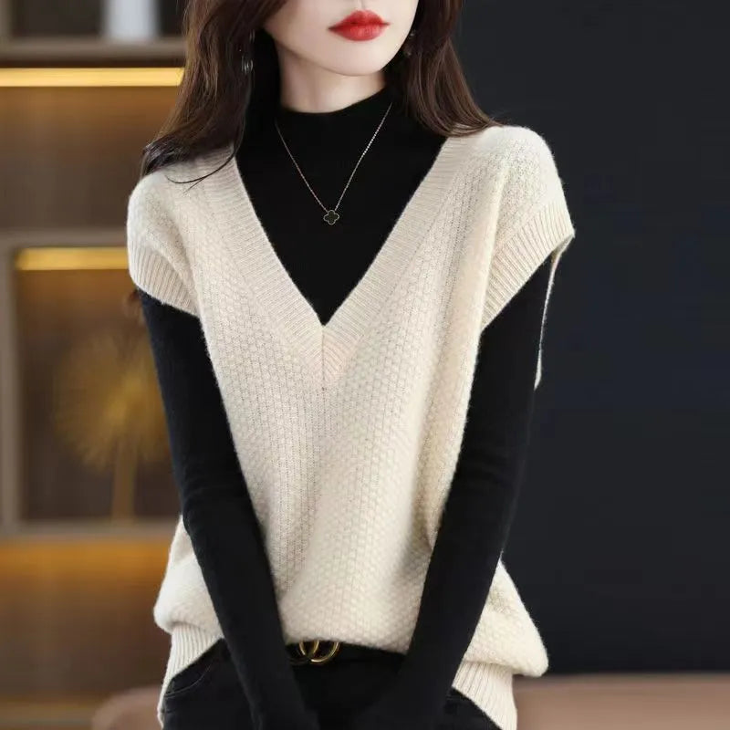 Women's creamy-white V-neck sleeveless knitted vest with a raised 3D stereoscopic pattern texture.