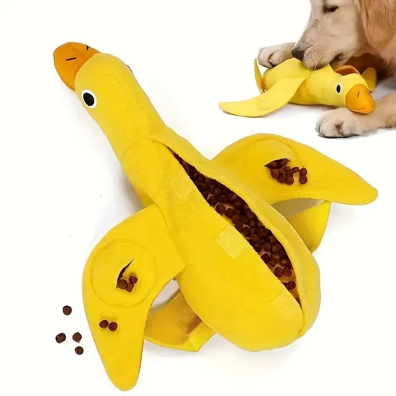 Yellow plush teddy dog toy with attached duck doll and food leak compartments for pet training