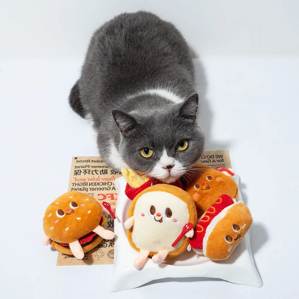 Assortment of kitten teething toys shaped like a hamburger, chicken leg, bread, fries, and hot dog.