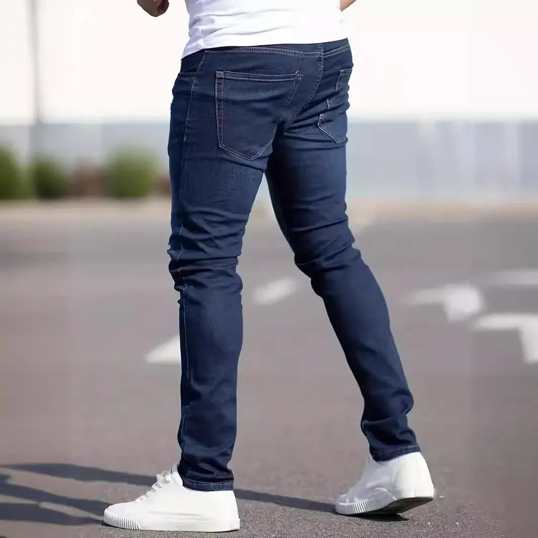 Men's dark blue cotton skinny jeans with elastic waistband shown on model