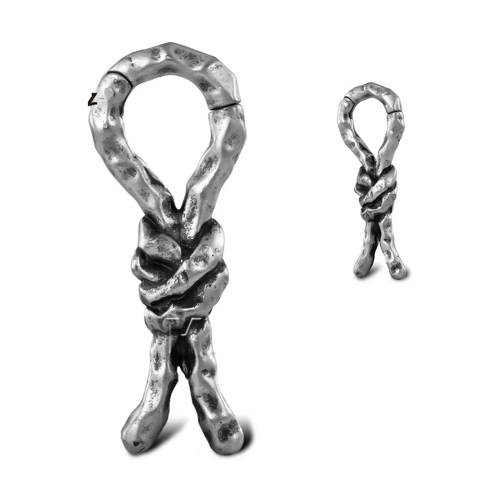 Copper bends and hitches piercing earring for auricle, showing sculptural shape and oiled finish.