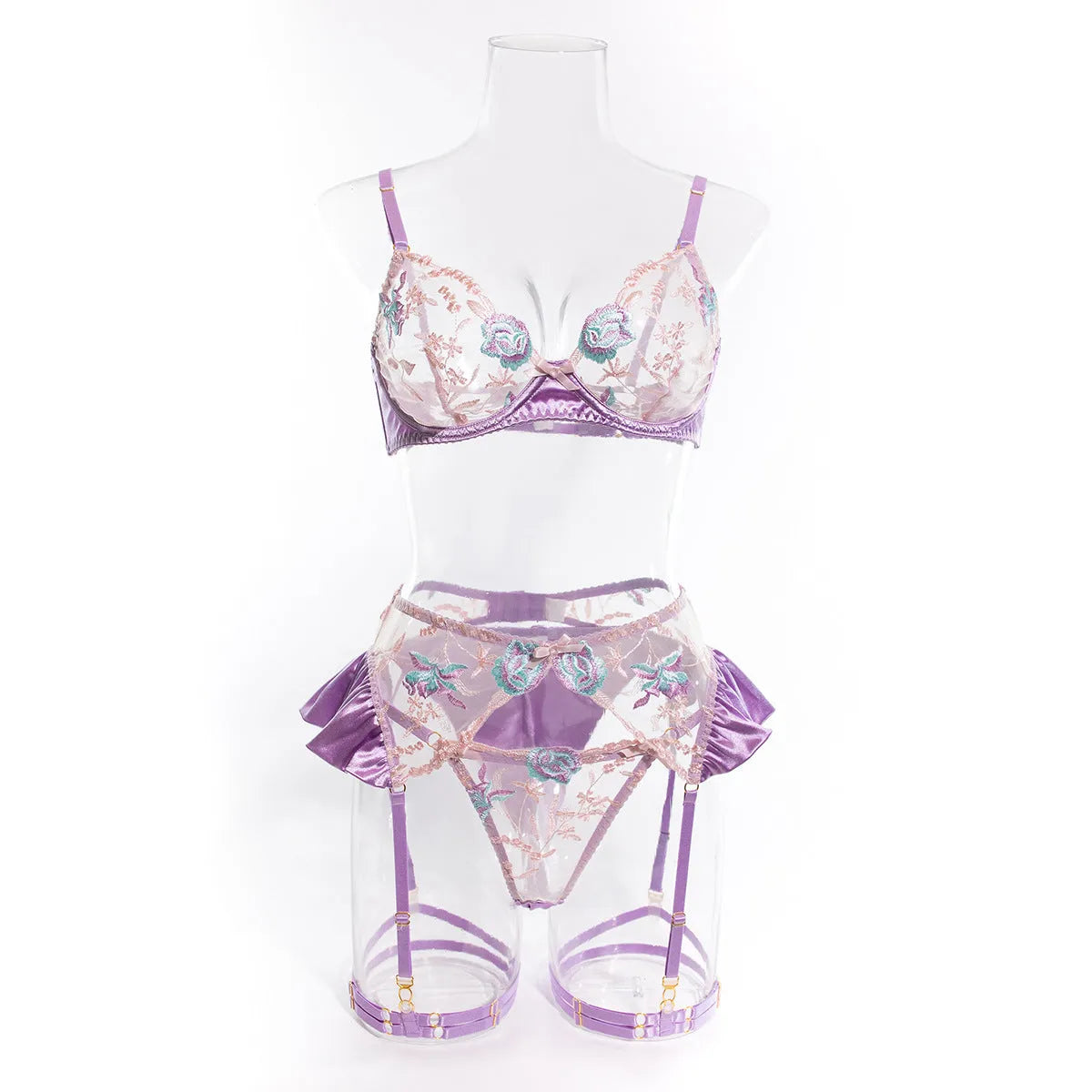 Light purple satin lingerie four-piece set with embroidery detailing on a hanger.