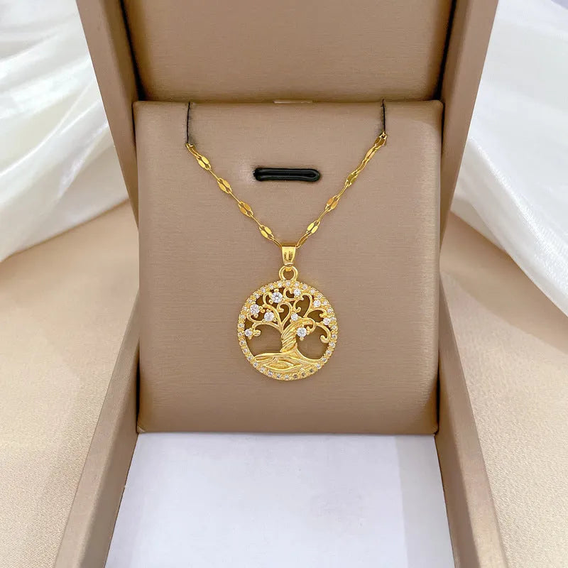 Gold plated stainless steel necklace with mother of pearl lucky tree pendant and cross elements on a lip chain