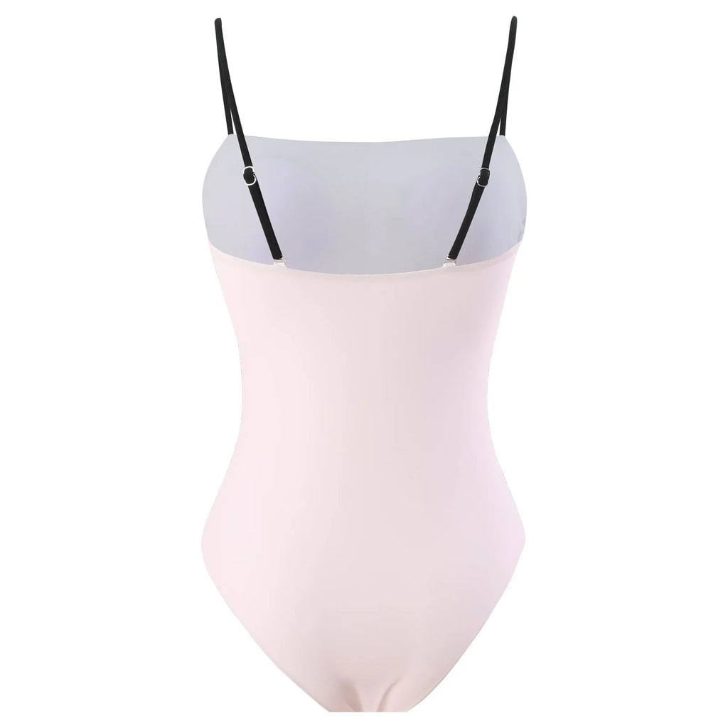 Women's patterned one-piece bikini swimsuit with a separate white tulle skirt laid flat.