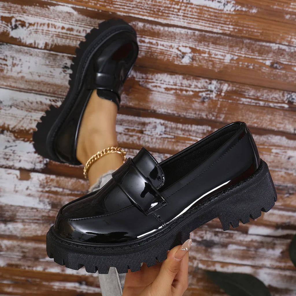 Plus size women's black slip-on loafers with a chunky platform heel and rubber sole