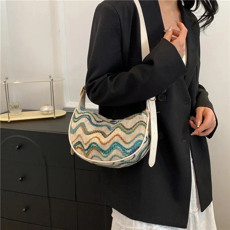 Women's knitted straw woven crossbody bag with single strap in corrugated black or khaki holding phone and files