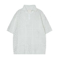 Solid colour loose-fit short-sleeved polo shirt with a hollow-knit design on a hanger.