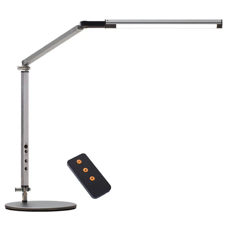 Black folding clip-on LED desk lamp with remote control on a wooden desk.