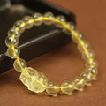 Yellow leather bracelet with an artificial citrine Pi Xiu charm in simple Chinese style.