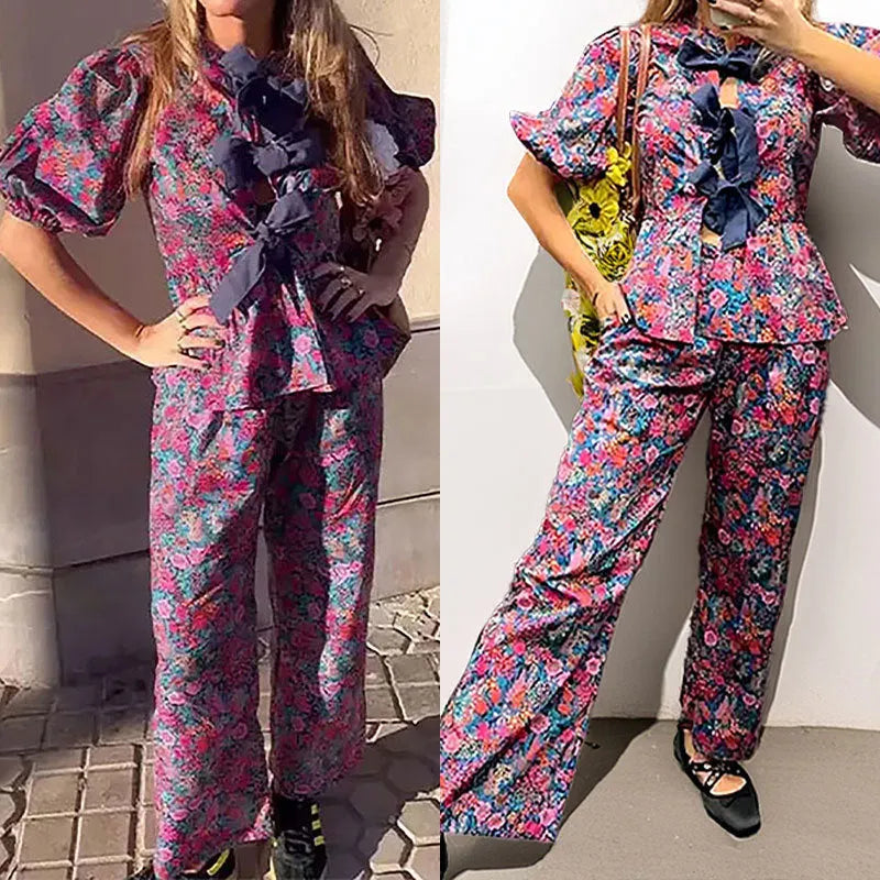 Floral print trousers suit with tie-neck blouse and puff sleeves on hanger