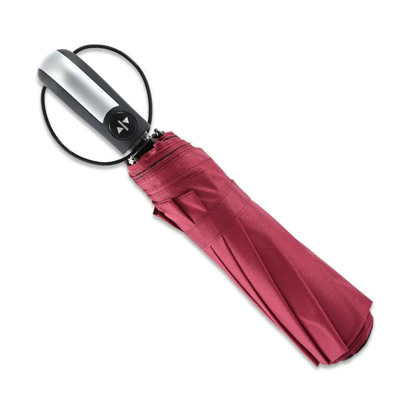 Triple-fold black automatic business umbrella with steel frame and rubber handle open.