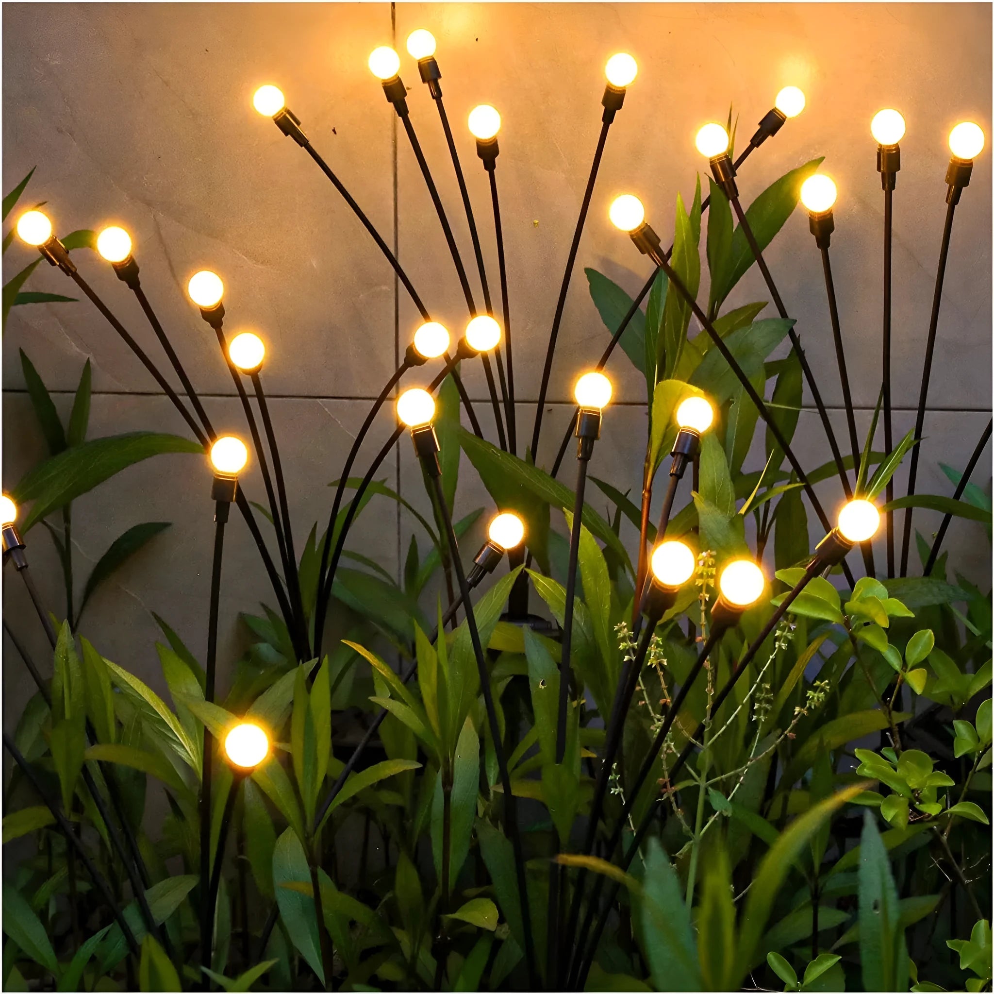 Solar-powered LED firefly ground spike light with multiple heads inserted along a garden path.