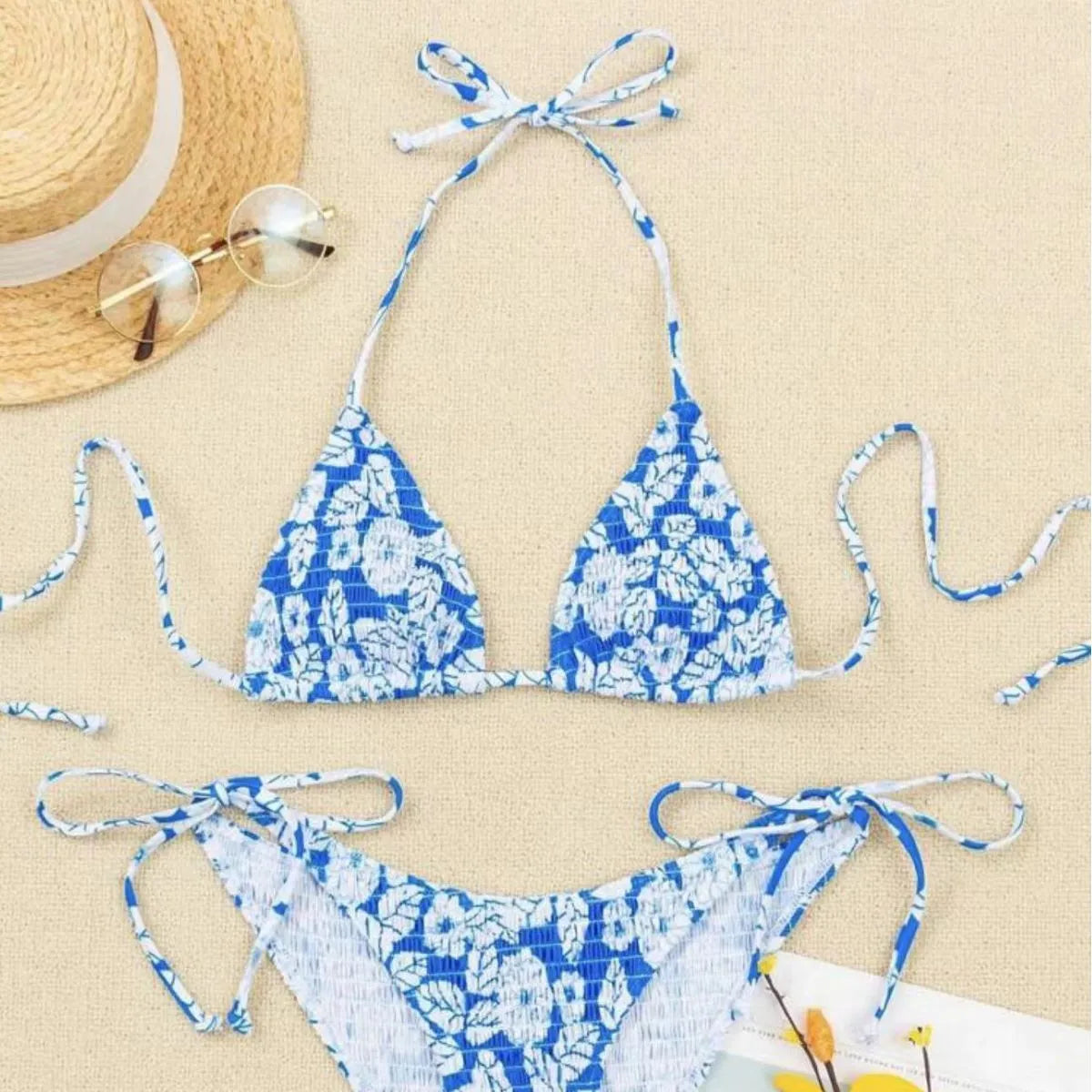 Women's floral pattern halter swimsuit briefs in light blue on a mannequin.