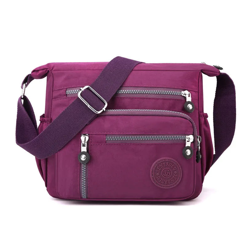 Grey nylon messenger bag with single shoulder strap showing square vertical shape and lining interior
