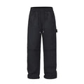 Black men's baggy paratrooper trousers with a drawstring elastic waistband on a plain background.