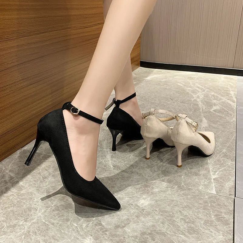 Black women's stiletto pump high heels with a skull-pattern buckle decoration on the front.