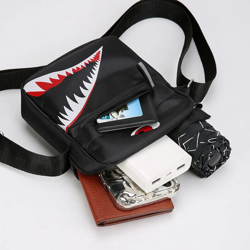 Men's small black Oxford cloth crossbody bag with an animal print pattern.
