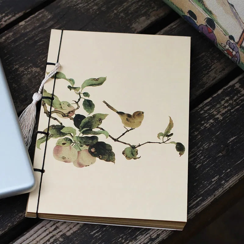 A5 antique wire-bound notebook with glossy embossed cover featuring a retro painting design, shown open.