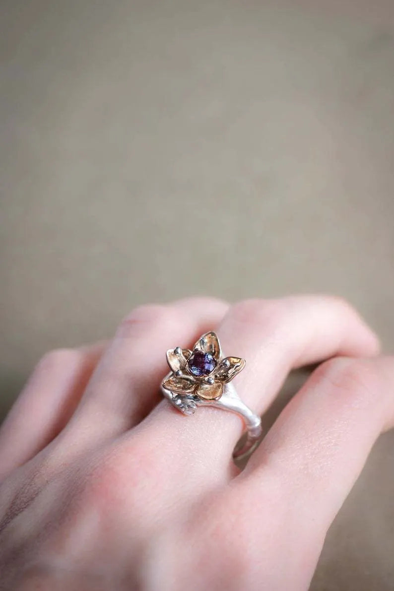 Silver two-tone women's ring with geometric floral design showing alloy construction and size options