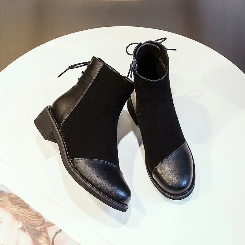Black women's Martin Boots with knee-length design, side zip closure, and decorative bow detail