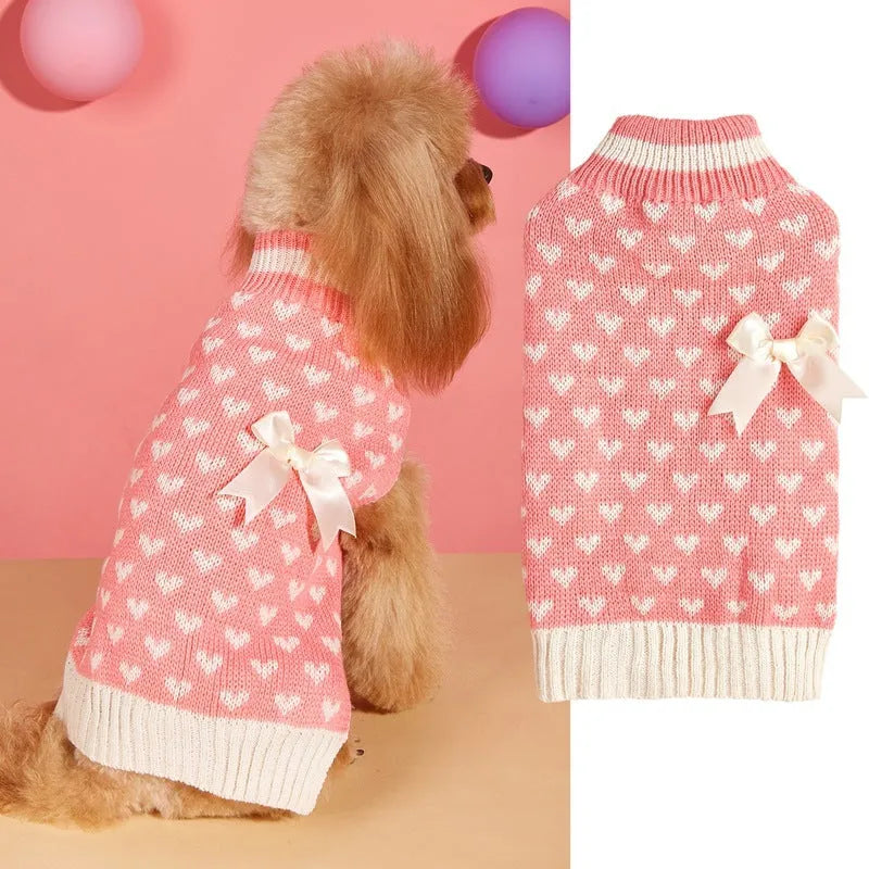 Red dog sweater with love heart design and bow decoration on small dog