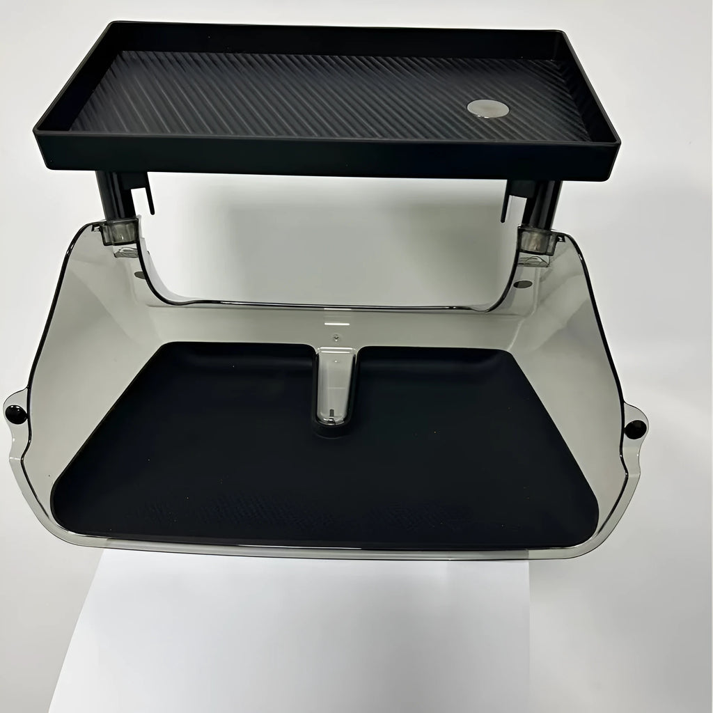 Black ABS plastic storage box installed under the touchscreen in a Tesla Model Y centre console.