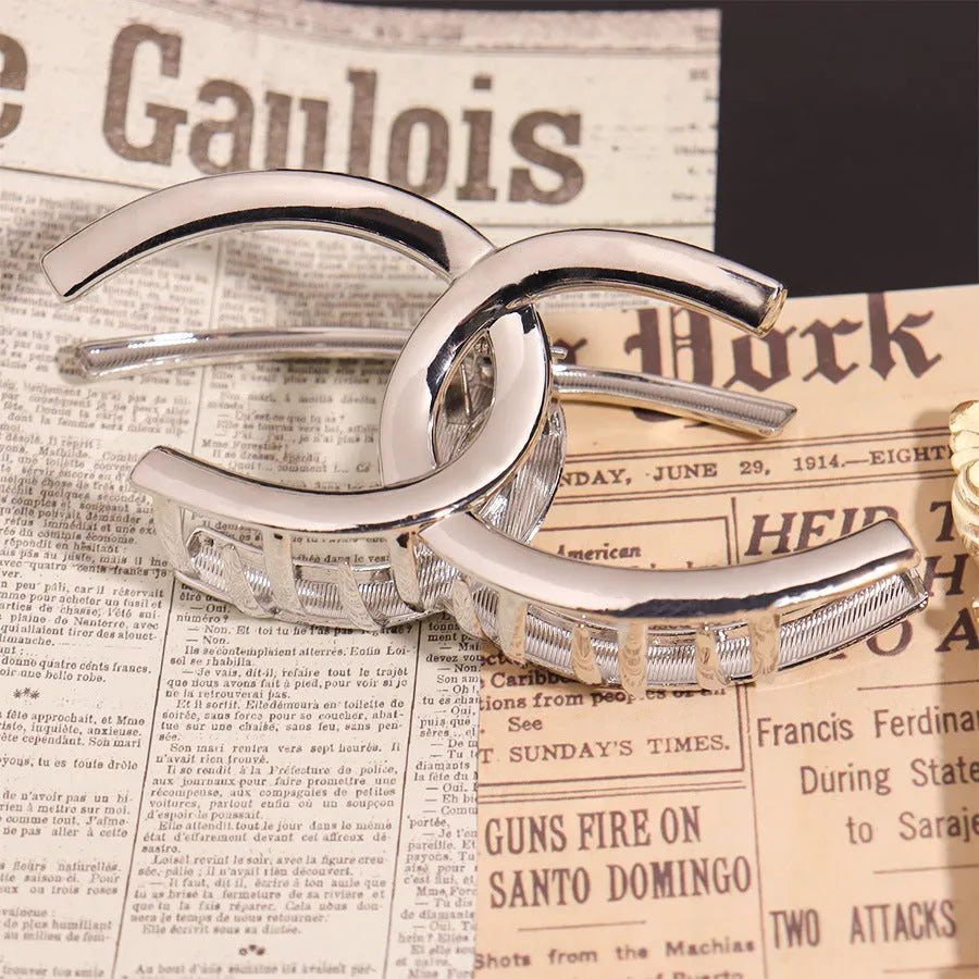 Silver metal hair clips collection with various Korean style designs including bows, pearls, and wave patterns