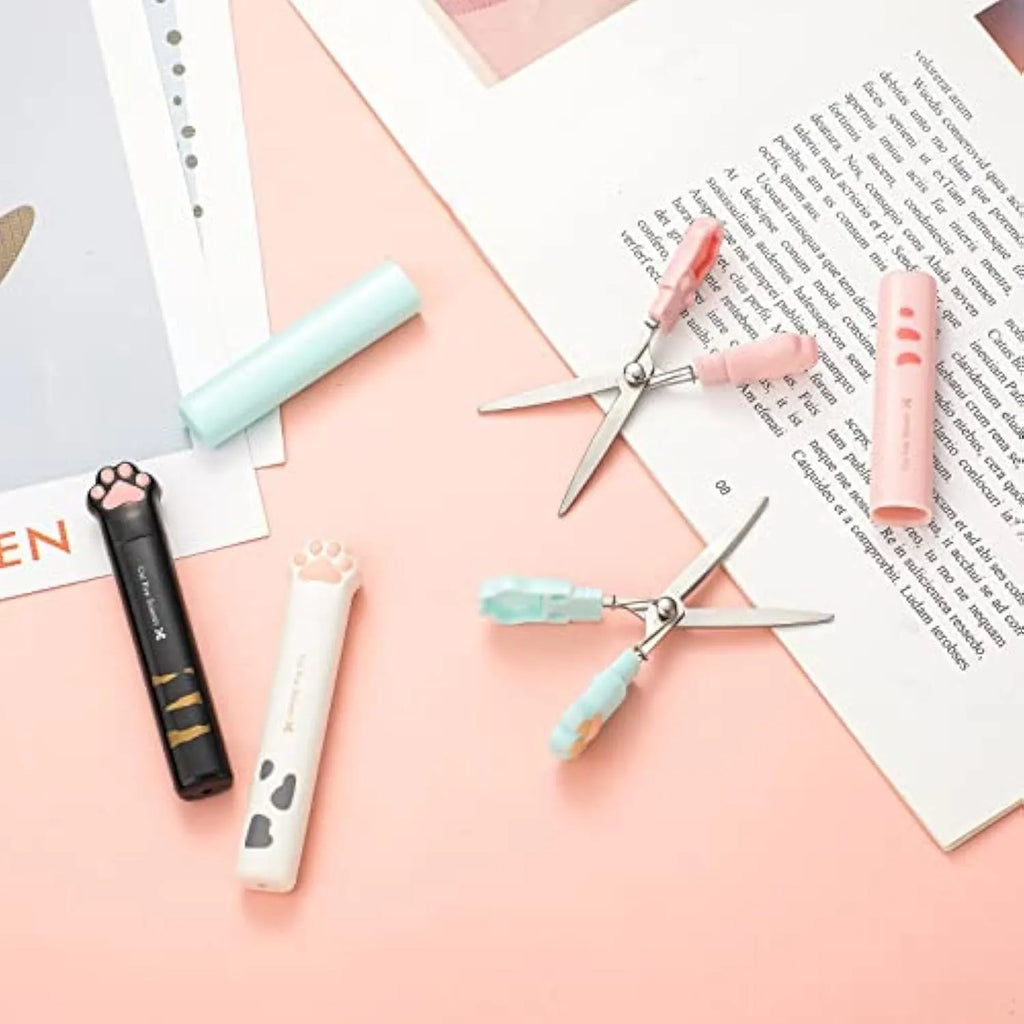 Closed and open views of cute cat paw design mini folding scissors in various colours.