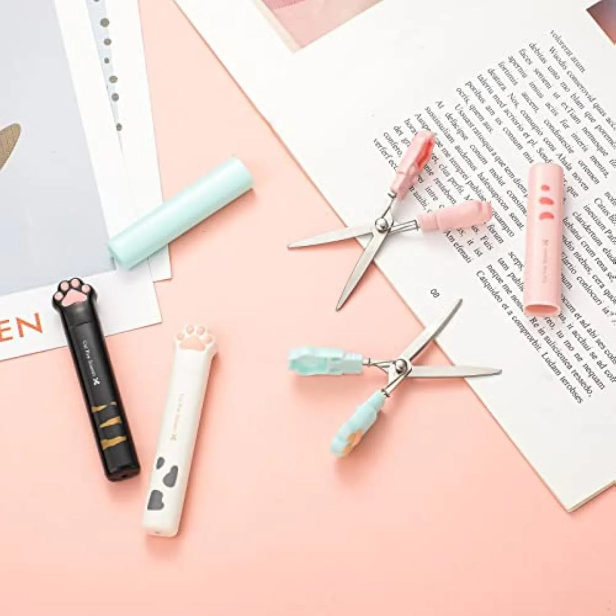 Closed and open views of cute cat paw design mini folding scissors in various colours.
