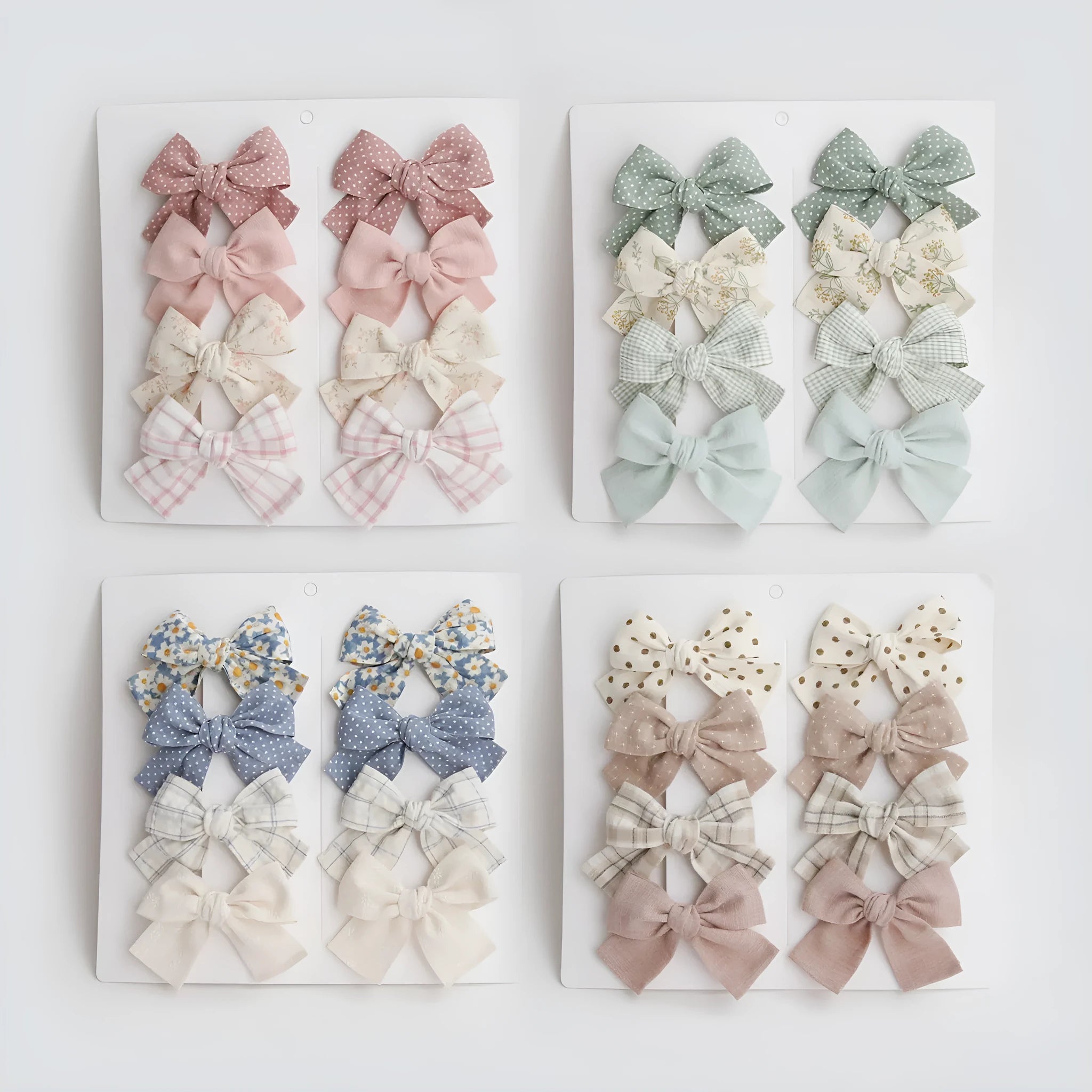 Set of eight children's cloth bow hair clips in various colours including beige polka dot, pink, blue floral, and wine red plaid patterns.